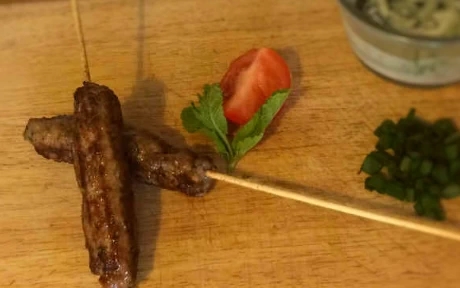two lamb koftas with a mint dip